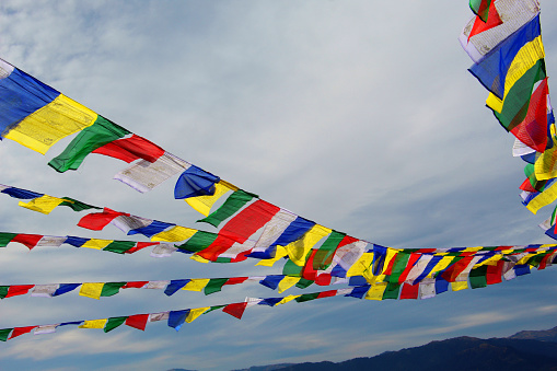 Buddhist Prayer Flags. Prayer flags are colorful panels of rectangular cloth that promote peace, compassion, strength, and wisdom in Tibetan Buddhism.
