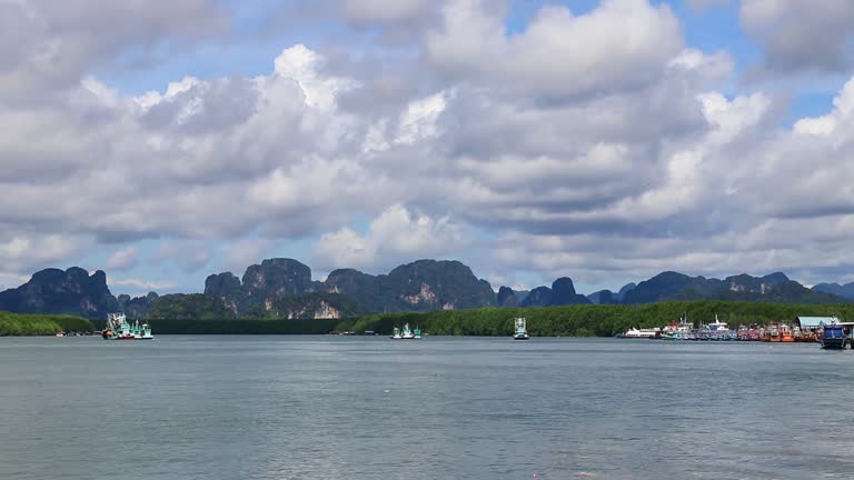 Tropical paradise turquoise water beach limestone rocks fisherboats Krabi T..