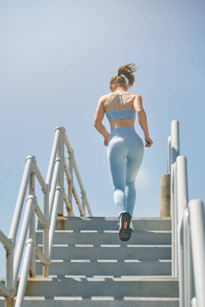 istock Faceless athlete running on stairs in sunlight 1887290474