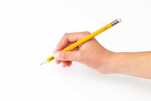 Child's hand holding a pencil.