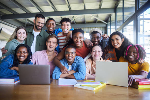 istock College teacher and his diverse class smiling in a cafeteria at school 1887302040
