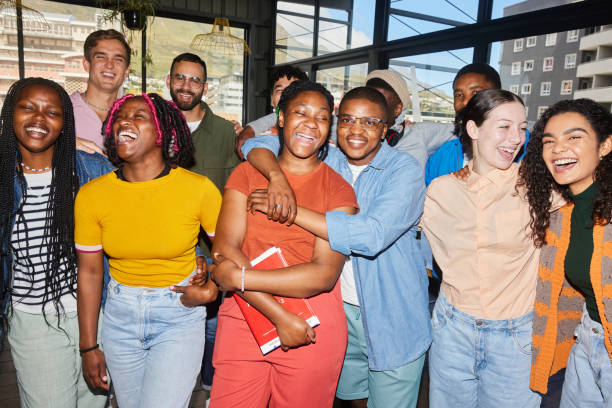 istock Class of diverse college students laughing with their teacher at school 1887305706