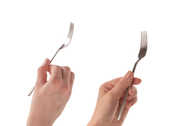 istock Fork in woman hand isolated on white. 1887328683