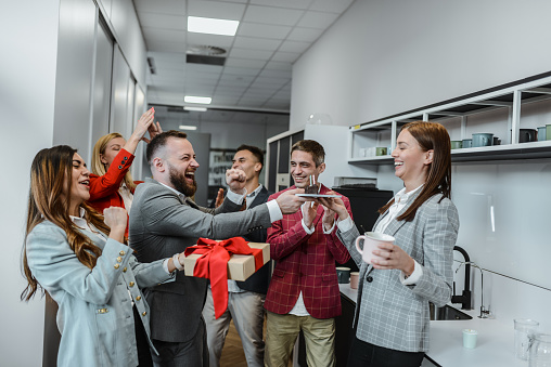 Surprise Birthday Cake Time For Businesswoman By Colleagues