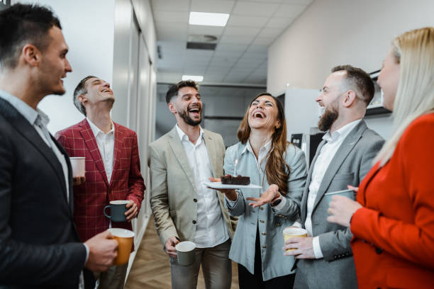 istock Birthday Female Laughs At Surprise Cake From Colleagues 1887358508