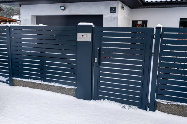 istock A modern gate with a letterbox and a wireless card reader, mounted in an anthracite panel fence, covered with snow. 1887359034