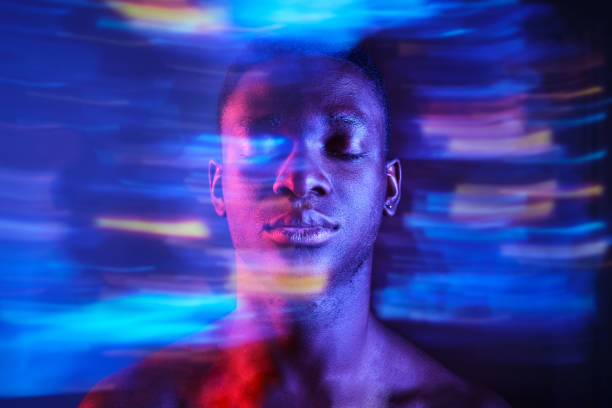 istock Black man with eyes closed in blurred blue lights 1887365306