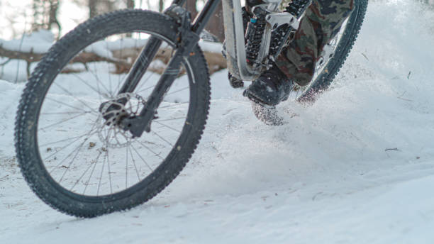 istock CLOSE UP: Winter mountain biking at adrenaline-filled snow-covered forest trail 1887366892