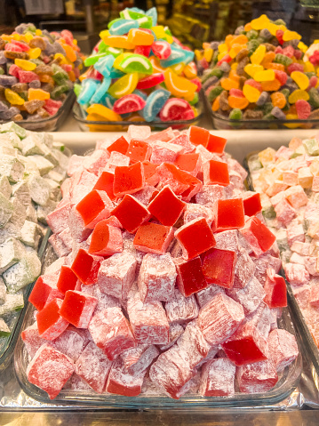 Turkish delight - LOKUM with a variety of nuts and flavours tastes in different colours. Huge variety of traditional eastern sweets at the Grand Bazaar in Istanbul, Turkey. Colourful food background with copy space.