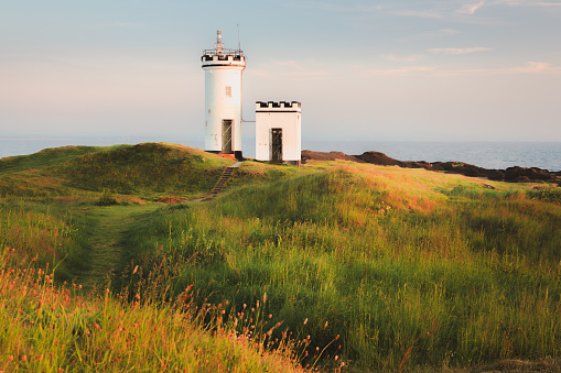 Scenic seascape landscape at sunset or sunrise of Elie Ness Lighthouse on the East Neuk Peninsula in coastal Fife, Scotland, UK.