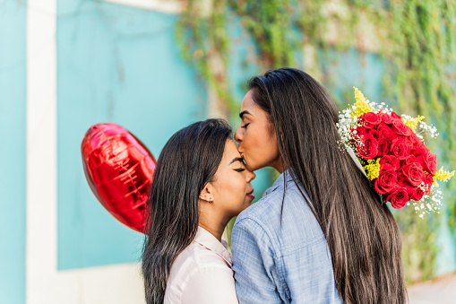 Lesbian woman kissing her girlfriend's forehead - Valentine's Day
