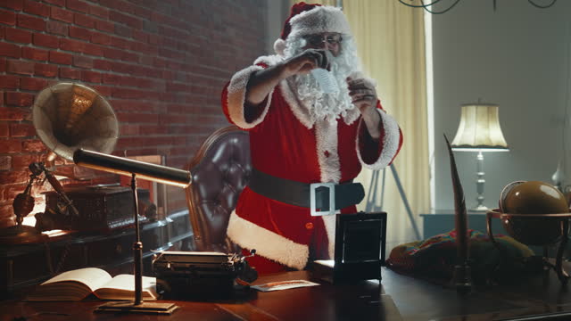 Santa dances in his workshop holding vacation tickets in his hands, looking forward to going on vacation. Happy excited Santa Claus holds a vacation tickets