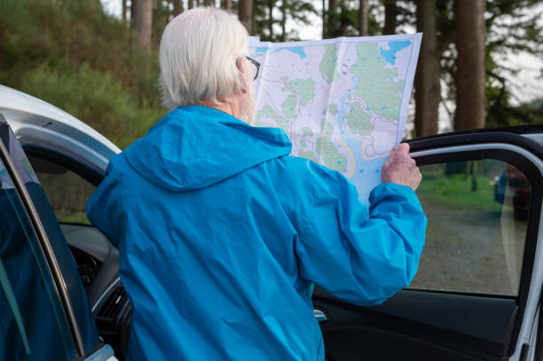 istock Rear view of a senior man looking at his map 1887417316