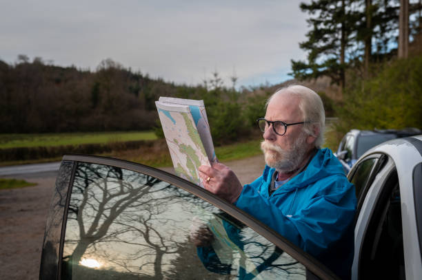 istock Front view of a senior man looking at his map 1887418850