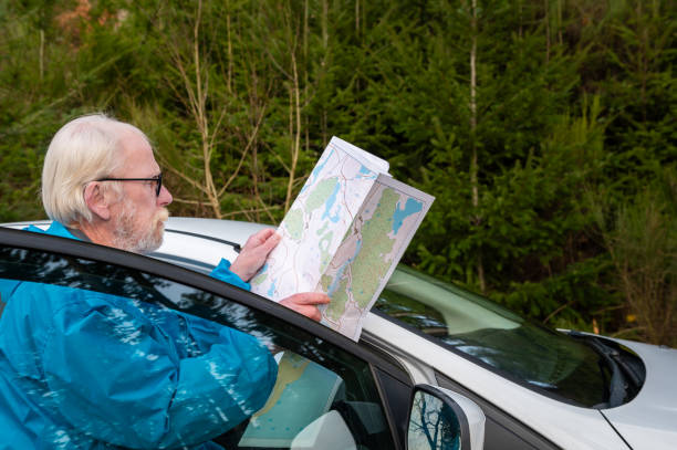 istock Side view of a retired man looking at his map 1887419867