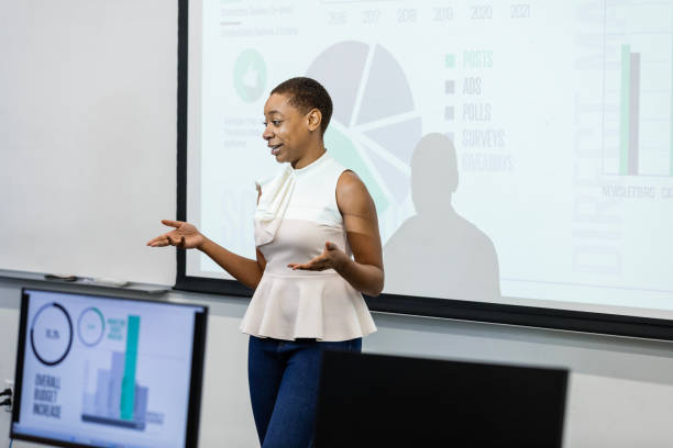 istock Mid adult female engineer gestures while speaking to her peers 1887419890