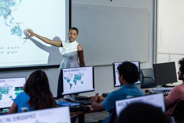 istock Young adult female trainer gestures while speaking to the class 1887420399