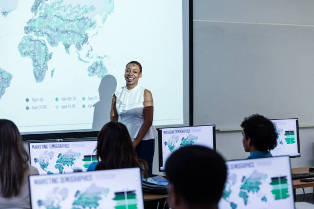 istock Young adult female smiles while presenting her project to the class 1887420400