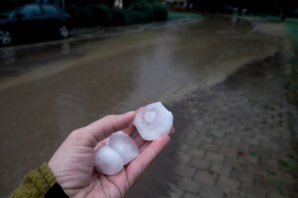 istock Natural disaster.Very large hail in hand close up. 1887426652