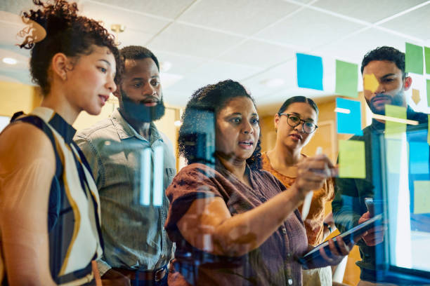 istock Diverse Professionals Brainstorming on Glass Wall 1887444243