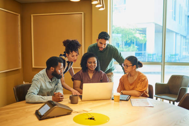 istock Diverse Colleagues Gathered Around Laptop in Office Brainstorming 1887444252