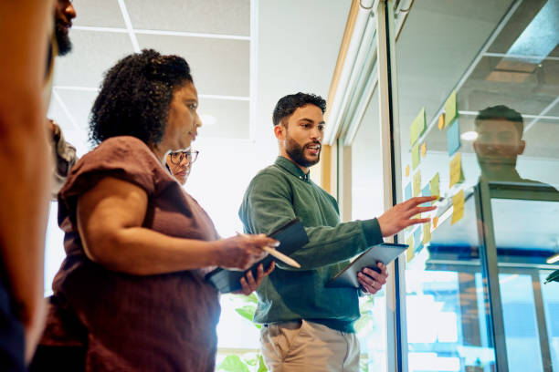 istock Diverse Professionals Brainstorming on a Glass Wall 1887444523