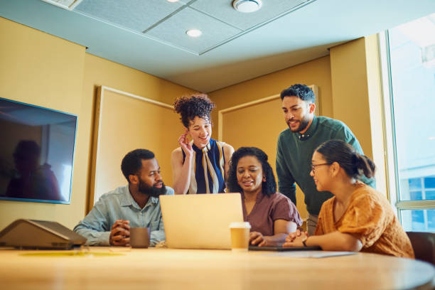 istock Diverse Team of Professionals Collaborating on a Project Using Laptop 1887444762