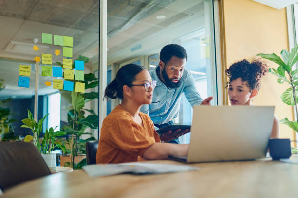 istock Colleagues discussing project in office 1887444771