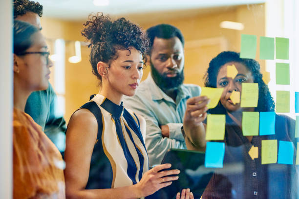istock Diverse Professionals Brainstorming on Glass Wall 1887444777