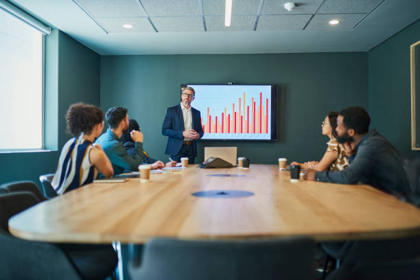 istock Confident Business Professionals in a Boardroom Meeting Led by a Senior Executive Analyzing Financial Performance Dat 1887448539