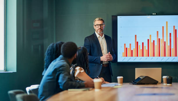 istock Business professionals in a meeting discussing financial data and graphs 1887449050