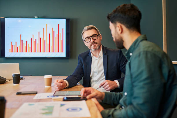 istock Confident Business Professionals Engaged in a Serious Discussion About Important Matters in a Modern Office Setting 1887449071