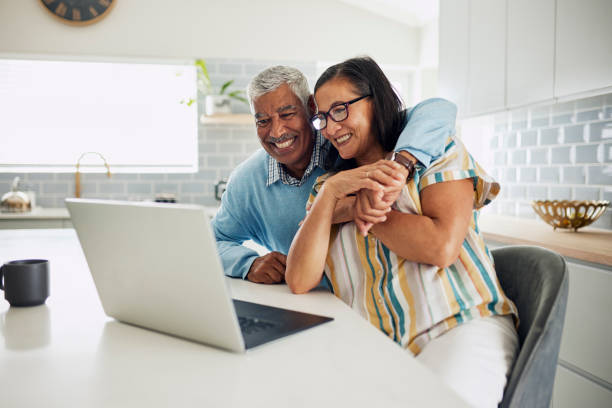 istock Happy Couple Looking at Laptop 1887469201