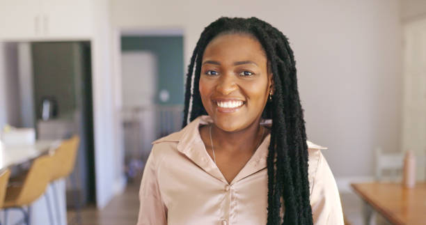 istock Confident Young Woman with Braids Smiling at Home 1887469770