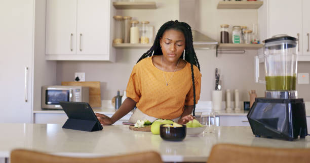istock Young Woman Reading Recipe On Tablet In Kitchen 1887470305