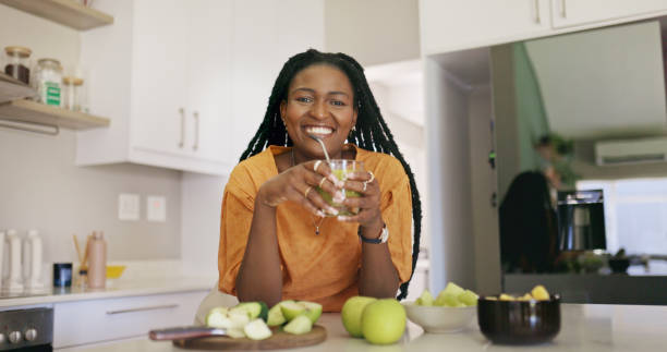 istock Black Woman In Kitchen With Green Smoothie And Apples 1887470676