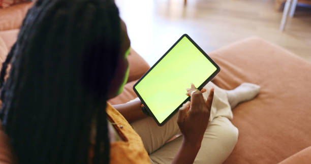 istock Relaxed young woman using laptop on couch 1887470862