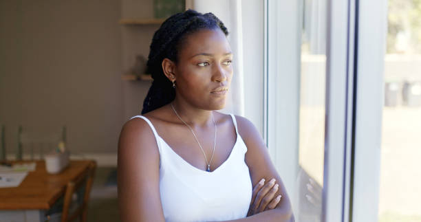 istock Thoughtful Woman Looking Out The Window 1887470896