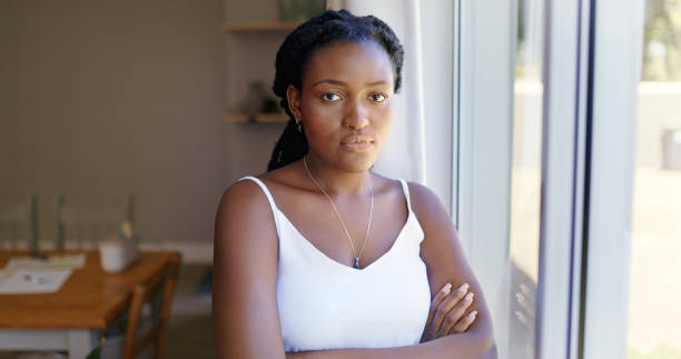 istock Serious woman looking out the window 1887470904