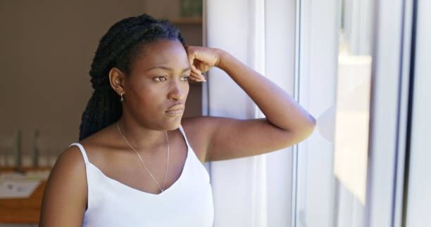istock Thoughtful Black Woman Looking Out The Window 1887470908