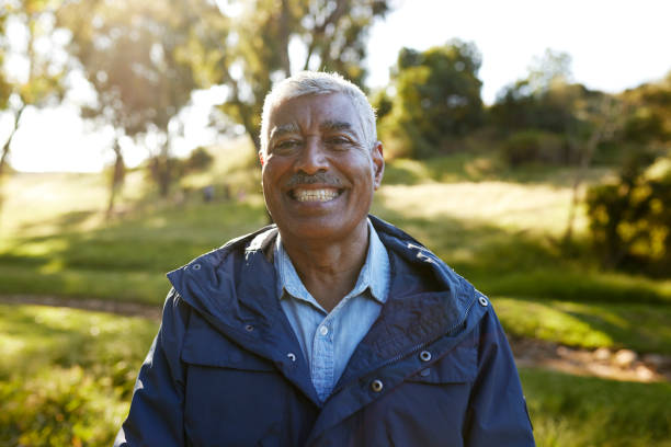 istock Smiling elderly man in a blue jacket standing in a field 1887472026