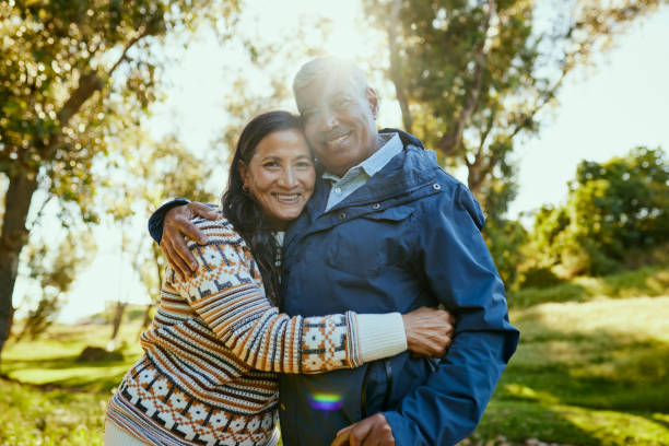 istock Happy Couple Embracing in the Park 1887472030