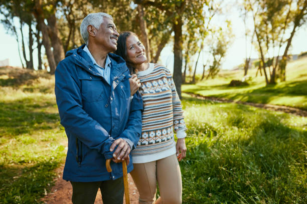 istock Happy Couple Embracing and Smiling While Standing in the Park 1887472036