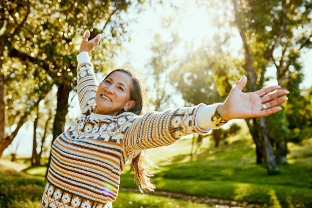 istock Ecstatic Woman Embracing Nature's Beauty in a Picturesque Forest Setting 1887472044