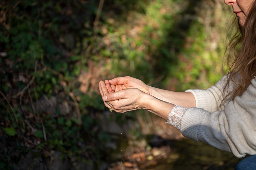 Middle aged woman doing relaxation exercise outdoor.