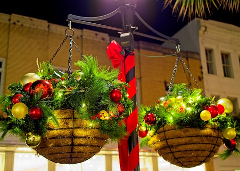 Christmas baskets with pine boughs, red ribbon, and ornaments in downtown Charleston South Carolina.