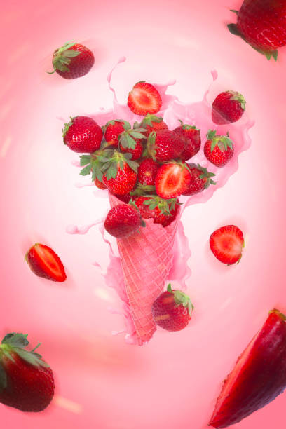 istock Ice cream cone with strawberry on the pink background. 1887550895