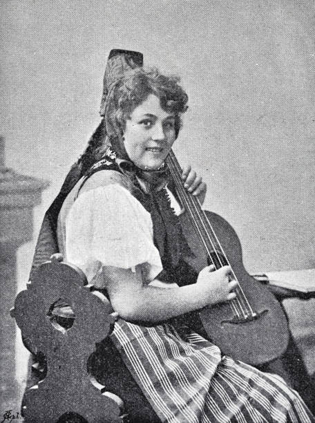 istock Young woman from the Black Forest holding a guitar 1887575950