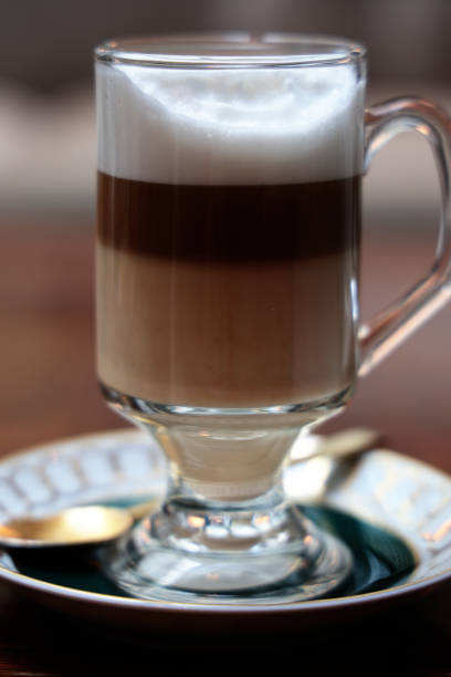 istock Cup of cafe latte with saucer and spoon 1887608405