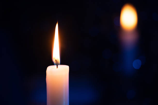 istock Candle background. Rainy night window, reflection of fire flame. 1887666103